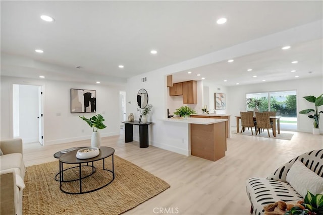 living room with light wood-type flooring, recessed lighting, and baseboards