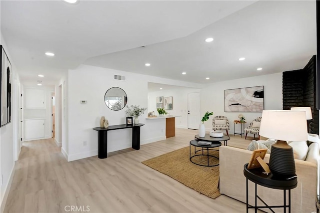living room featuring light wood-style flooring, recessed lighting, and baseboards