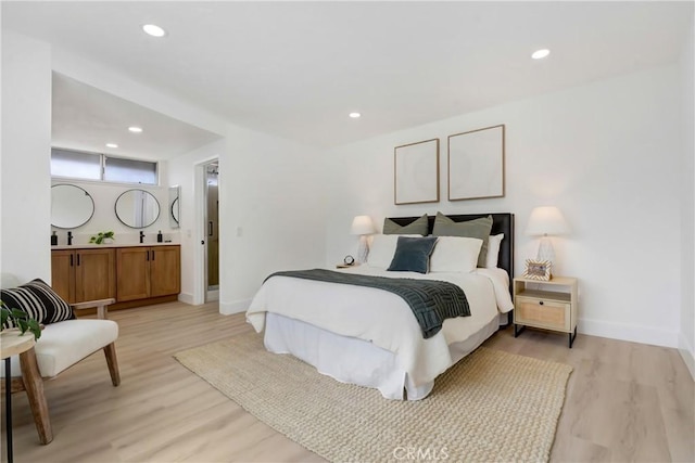 bedroom with light wood-type flooring, baseboards, and recessed lighting