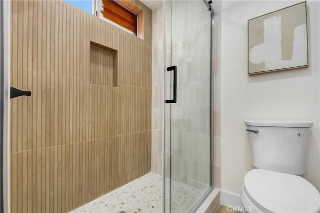 full bath featuring a shower stall and toilet