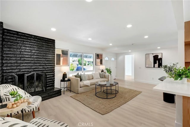 6445 Beryl St, Rancho Cucamonga, CA 91701 - living room with light wood-style floors, recessed lighting, baseboards, and a fireplace