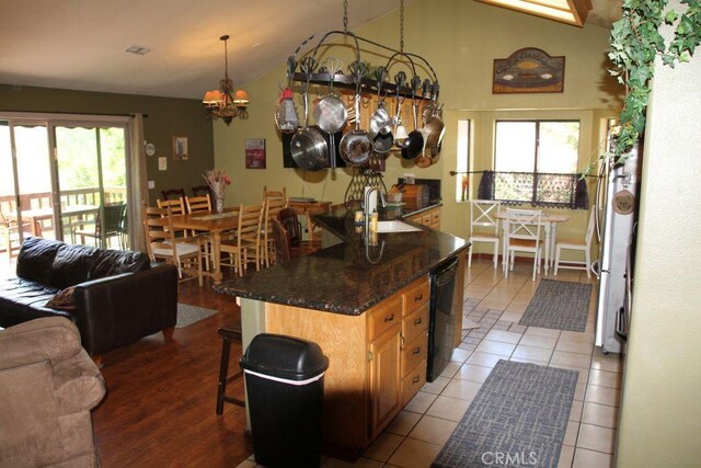 2205 Freeman Dr, Pine Mountain Club, CA 93225 - kitchen featuring a sink, lofted ceiling, black dishwasher, a chandelier, and a kitchen bar