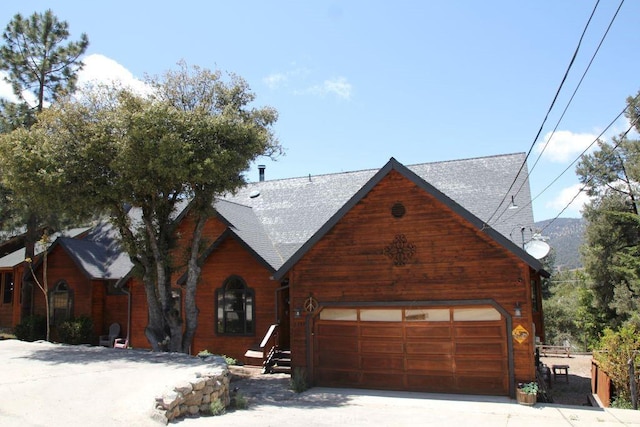 2205 Freeman Dr, Pine Mountain Club, CA 93225 - view of front of property featuring a garage, a shingled roof, and driveway