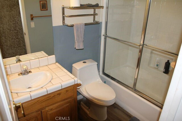 2205 Freeman Dr, Pine Mountain Club, CA 93225 - bathroom featuring toilet, vanity, and bath / shower combo with glass door
