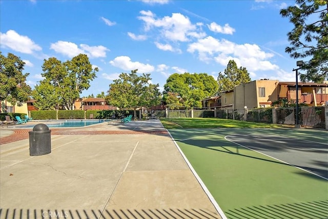 1000 W Macarthur Blvd Unit 44, Santa Ana, CA 92707 - view of tennis court with fence, a community pool, and a residential view