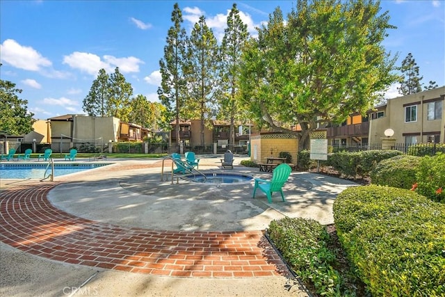 1000 W Macarthur Blvd Unit 44, Santa Ana, CA 92707 - view of property's community featuring a swimming pool, fence, a jacuzzi, a patio, and a residential view