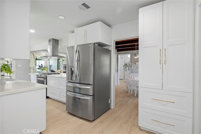 19129 E Orangepath St, Glendora, CA 91741 - kitchen with appliances with stainless steel finishes, island exhaust hood, white cabinetry, light wood-style floors, and recessed lighting