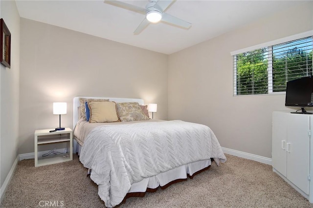 bedroom with light carpet, baseboards, and ceiling fan