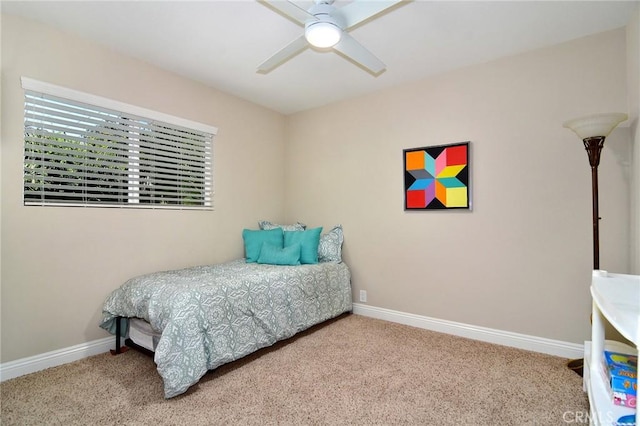 bedroom with carpet flooring, baseboards, and a ceiling fan