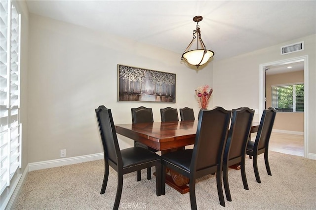 dining room with carpet and baseboards