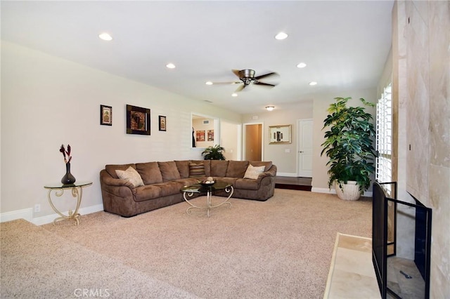 carpeted living area featuring ceiling fan, recessed lighting, and baseboards