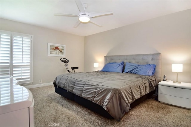carpeted bedroom featuring baseboards and ceiling fan