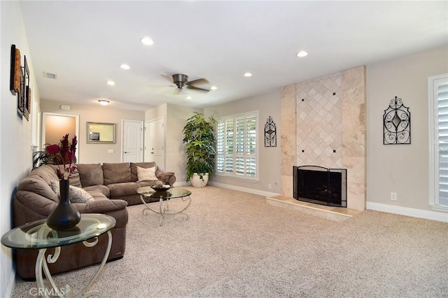 carpeted living area featuring a tiled fireplace, recessed lighting, baseboards, and a ceiling fan