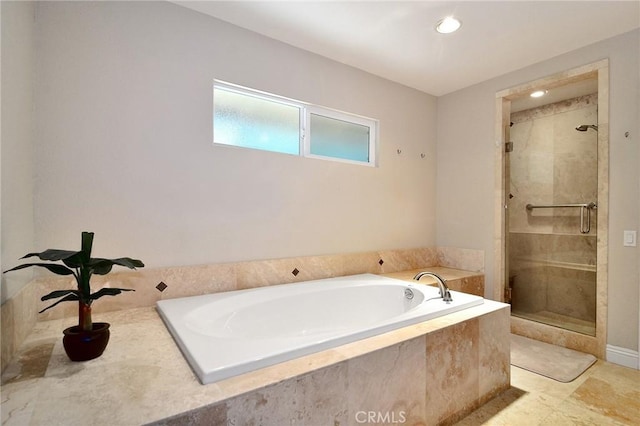 bathroom featuring a stall shower, a garden tub, and recessed lighting