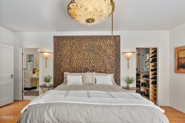 2707 Hermosita Dr, Glendale, CA 91208 - bedroom with ornamental molding, wood finished floors, a spacious closet, connected bathroom, and a closet