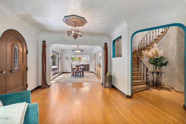 2707 Hermosita Dr, Glendale, CA 91208 - foyer entrance featuring arched walkways, stairway, and wood finished floors