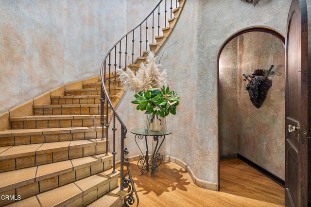 2707 Hermosita Dr, Glendale, CA 91208 - stairs featuring wood finished floors and arched walkways