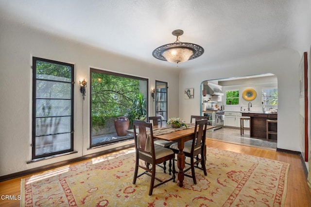 2707 Hermosita Dr, Glendale, CA 91208 - dining room with arched walkways and light wood-style floors