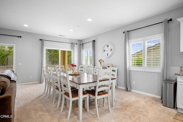 dining area featuring baseboards, recessed lighting, and light carpet