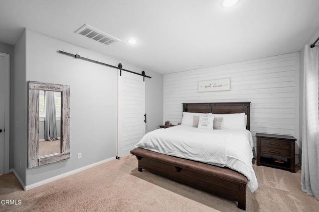 carpeted bedroom with a barn door, recessed lighting, and baseboards