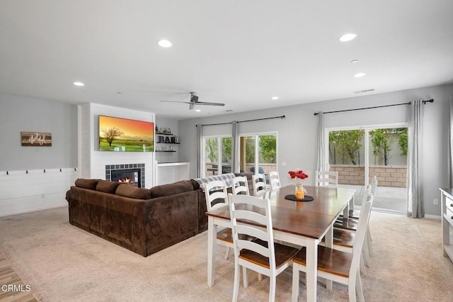 dining space with plenty of natural light, ceiling fan, recessed lighting, and a tile fireplace