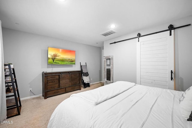 bedroom with a barn door, carpet floors, baseboards, and recessed lighting