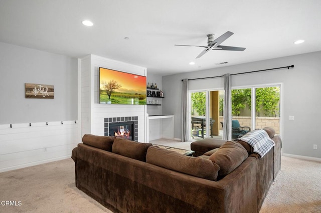 carpeted living room featuring recessed lighting, a tile fireplace, ceiling fan, and baseboards
