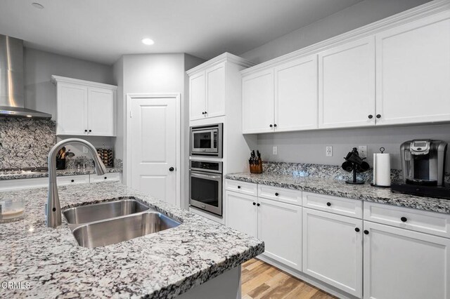17837 Grapevine Ln, San Bernardino, CA 92407 - kitchen featuring wall chimney exhaust hood, stainless steel appliances, recessed lighting, and white cabinetry