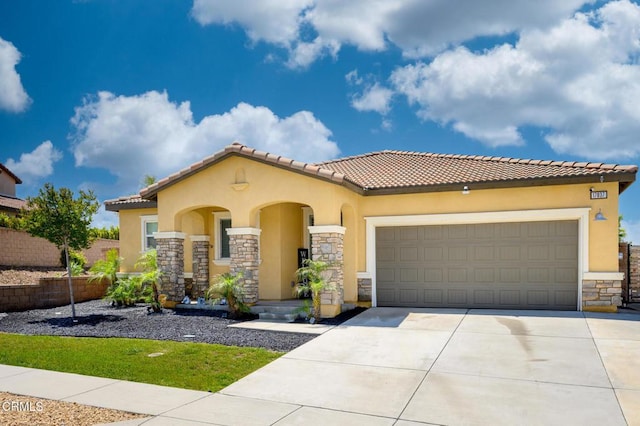 17837 Grapevine Ln, San Bernardino, CA 92407 - mediterranean / spanish house featuring stone siding, stucco siding, driveway, an attached garage, and a tile roof