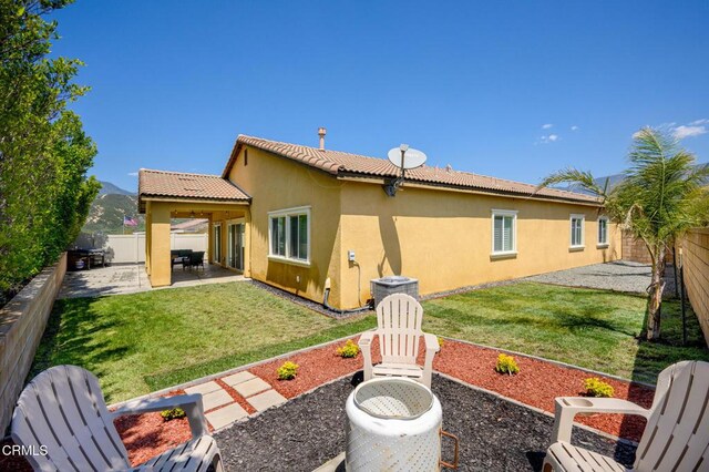 17837 Grapevine Ln, San Bernardino, CA 92407 - rear view of property featuring stucco siding, a patio, and a fenced backyard