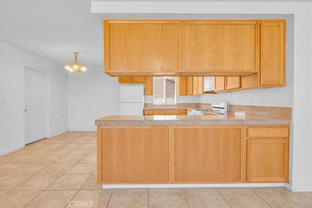 72454 El Paseo Dr Unit 29, Palms, CA 92277 - kitchen with white appliances, a peninsula, a chandelier, light countertops, and light tile patterned floors