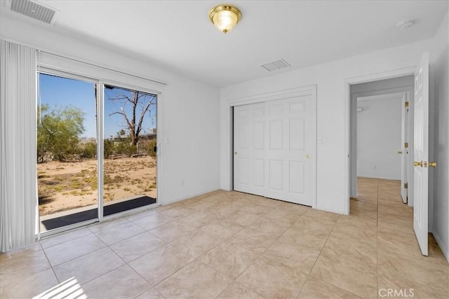 72454 El Paseo Dr Unit 29, Palms, CA 92277 - unfurnished bedroom featuring access to exterior, a closet, and light tile patterned floors