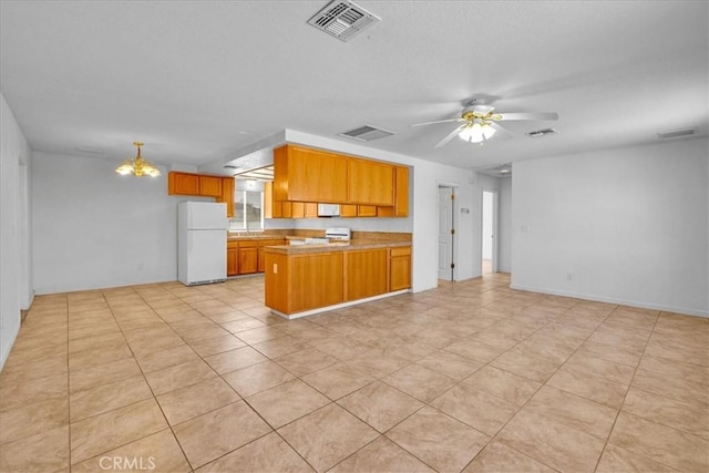72454 El Paseo Dr Unit 29, Palms, CA 92277 - kitchen featuring white appliances, a peninsula, open floor plan, brown cabinets, and ceiling fan