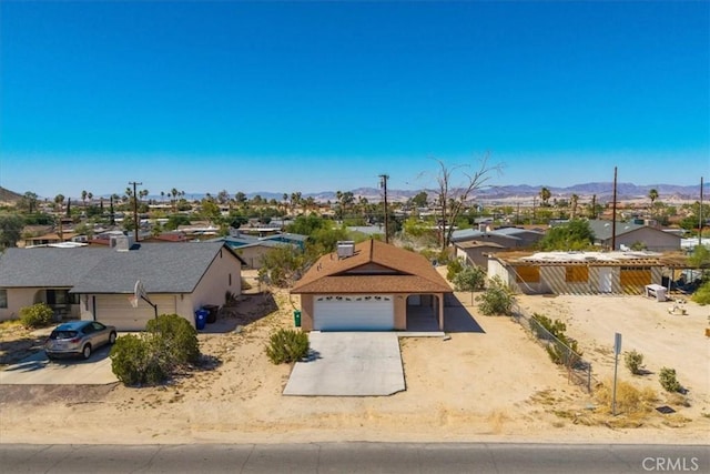 72454 El Paseo Dr Unit 29, Palms, CA 92277 - view of front of property with a residential view, a garage, and a mountain view