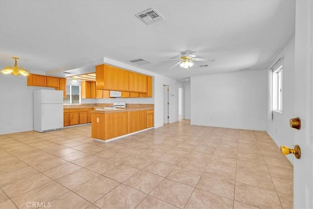 72454 El Paseo Dr Unit 29, Palms, CA 92277 - kitchen featuring freestanding refrigerator, open floor plan, a peninsula, light countertops, and a ceiling fan