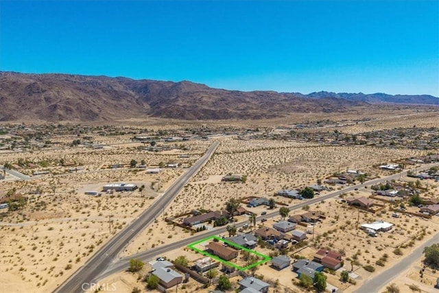 72454 El Paseo Dr Unit 29, Palms, CA 92277 - aerial view of sparsely populated area featuring a mountainous background and property parcel outlined