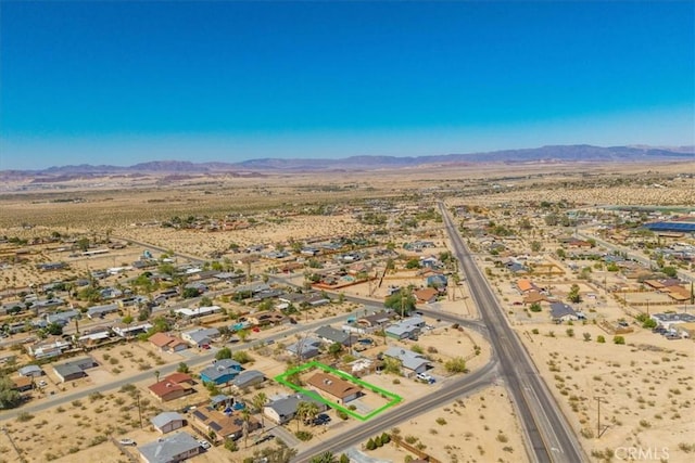 72454 El Paseo Dr Unit 29, Palms, CA 92277 - aerial view of residential area featuring a mountain backdrop and a desert landscape