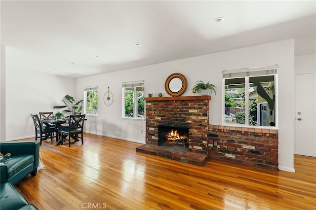 3316 Henrietta Ave, La Crescenta, CA 91214 - living area with hardwood / wood-style floors, a brick fireplace, and baseboards