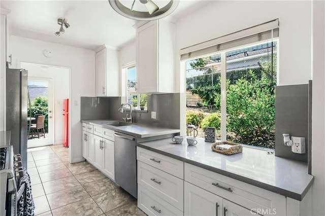 3316 Henrietta Ave, La Crescenta, CA 91214 - kitchen featuring appliances with stainless steel finishes, healthy amount of natural light, white cabinetry, and a sink