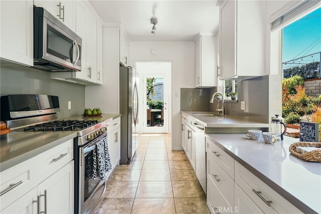 3316 Henrietta Ave, La Crescenta, CA 91214 - kitchen featuring stainless steel appliances, a sink, plenty of natural light, and white cabinets