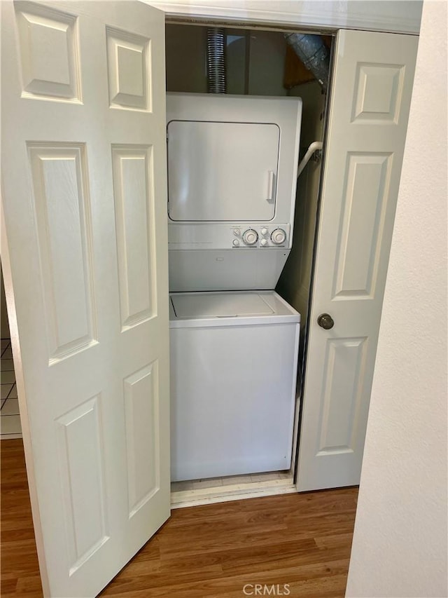 21203 Camelia Unit 34, Lake Forest, CA 92630 - laundry area featuring estacked washer and dryer and wood finished floors