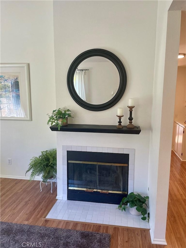 21203 Camelia Unit 34, Lake Forest, CA 92630 - detailed view of a tiled fireplace, wood finished floors, and baseboards
