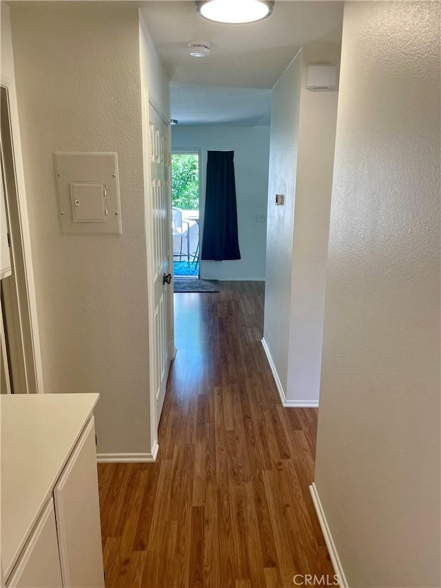 21203 Camelia Unit 34, Lake Forest, CA 92630 - hallway with dark wood-style floors, baseboards, electric panel, and a textured wall