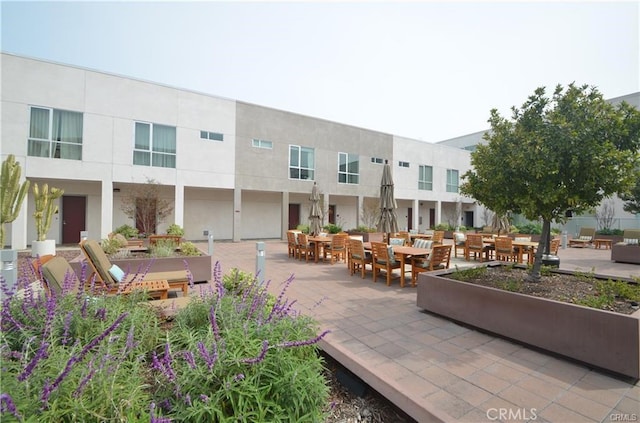 view of home's community featuring outdoor dining area