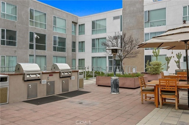 view of patio featuring grilling area, exterior kitchen, and outdoor dining area
