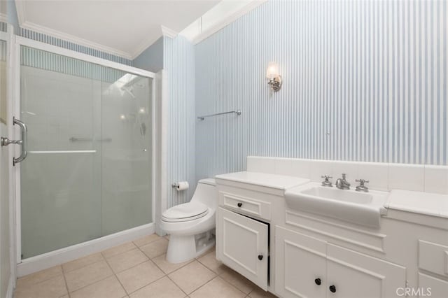 bathroom featuring tile patterned flooring, crown molding, toilet, a shower stall, and vanity