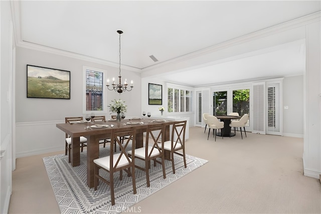dining space with crown molding, light carpet, a chandelier, and baseboards