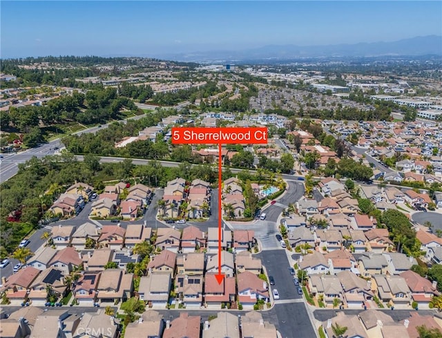 aerial overview of property's location featuring a mountain backdrop and nearby suburban area