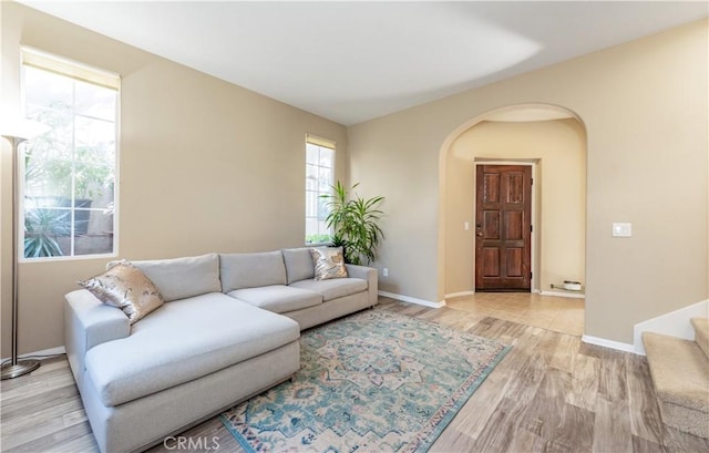80 Great Lawn, Irvine, CA 92620 - living area featuring wood finished floors, arched walkways, and baseboards