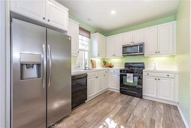 80 Great Lawn, Irvine, CA 92620 - kitchen with black appliances, a sink, white cabinets, light countertops, and light wood-type flooring